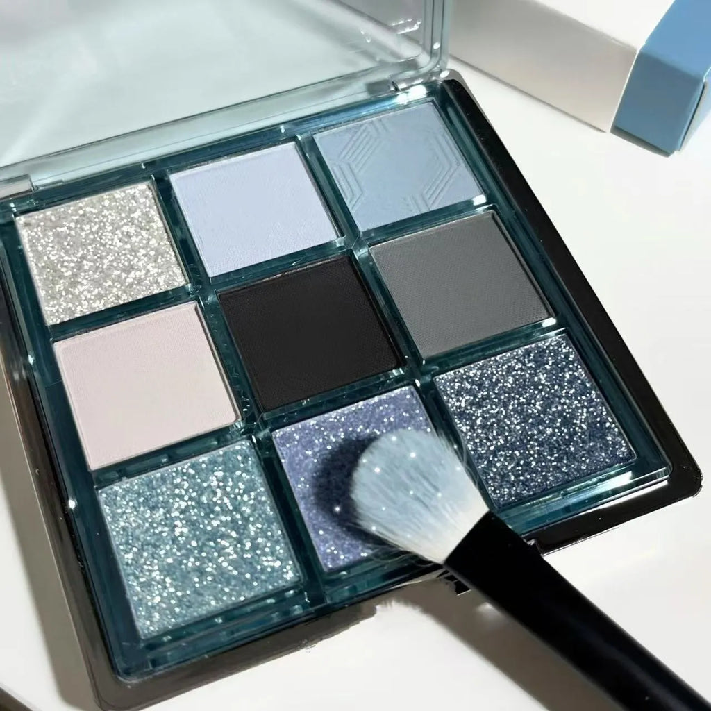 MUGELEEN nine-colour eye shadow palette showing blue smoked earth tones with matte and shimmer textures