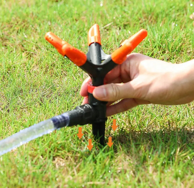 Orange plastic garden insert sprinkler with rotating water spray, 14 x 26.5cm, single nozzle