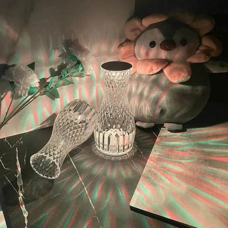 Vase-shaped crystal table lamp with LED lights and remote control on wooden bedside table