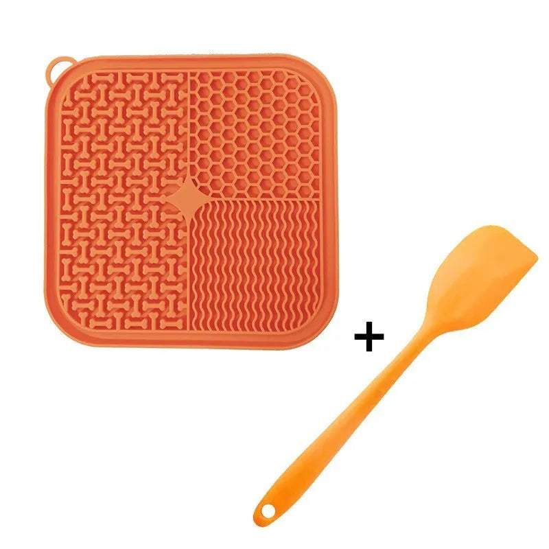 Square orange silicone dog licking mat with suction cups on back and textured surface