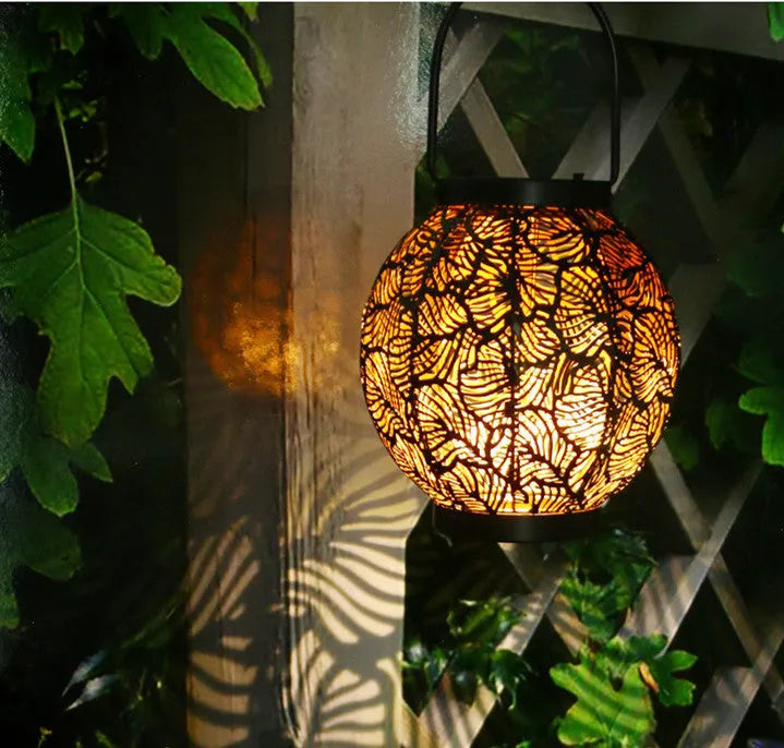 Decorative hollow iron solar courtyard lamp with integrated solar panel and warm white LED illumination