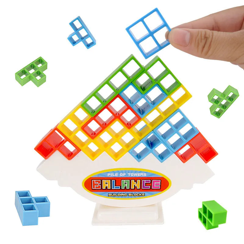 Plastic balance stacking game with 16 colourful building blocks, chassis, and base on a table.