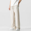 Men's beige bamboo fibre loose straight-leg casual trousers with a drawstring waist, shown on a hanger.