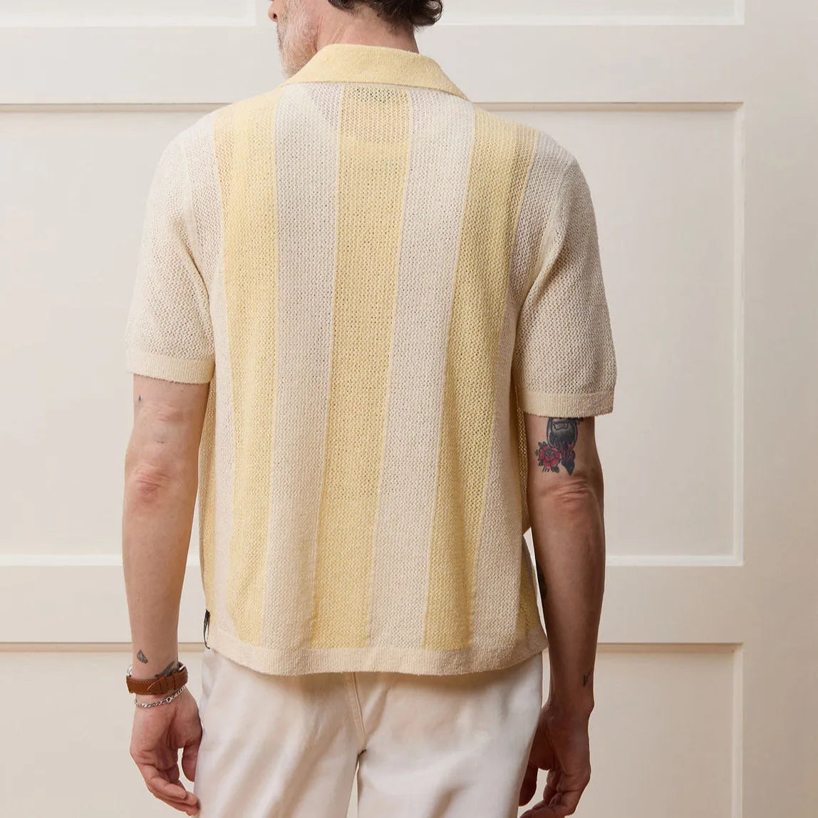Yellow men's casual polo shirt with asymmetric design and short sleeves made from Tencel fabric.
