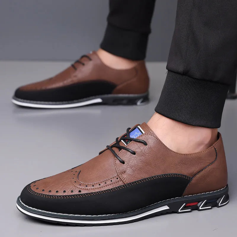 Men's black leather-toe casual shoes with a fabric upper and rubber sole on a plain background.