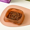Blue plastic dog slow feeder bowl with anti-choking design on a white background