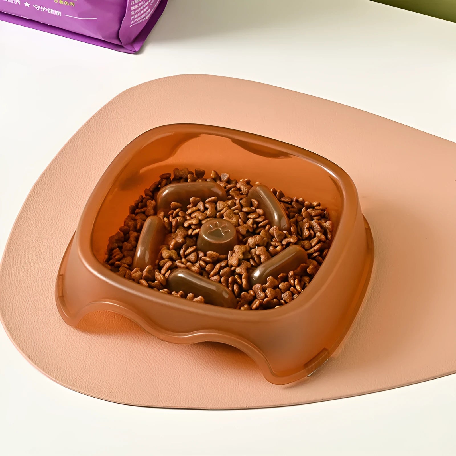 Blue plastic dog slow feeder bowl with anti-choking design on a white background