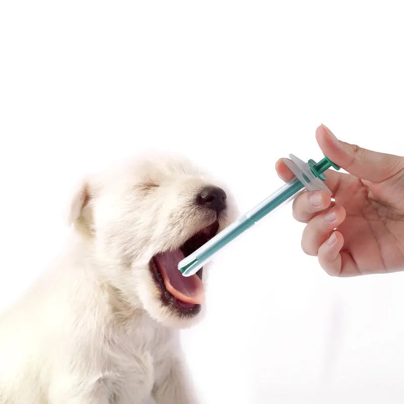 Two white pet pill shooter dispensers with soft silicone tips and push rods for administering tablets to cats and dogs.