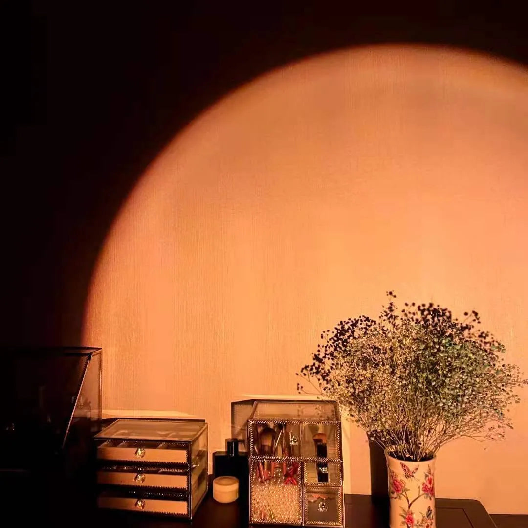 Rechargeable sunset projection lamp showing rainbow colour effects with USB cable