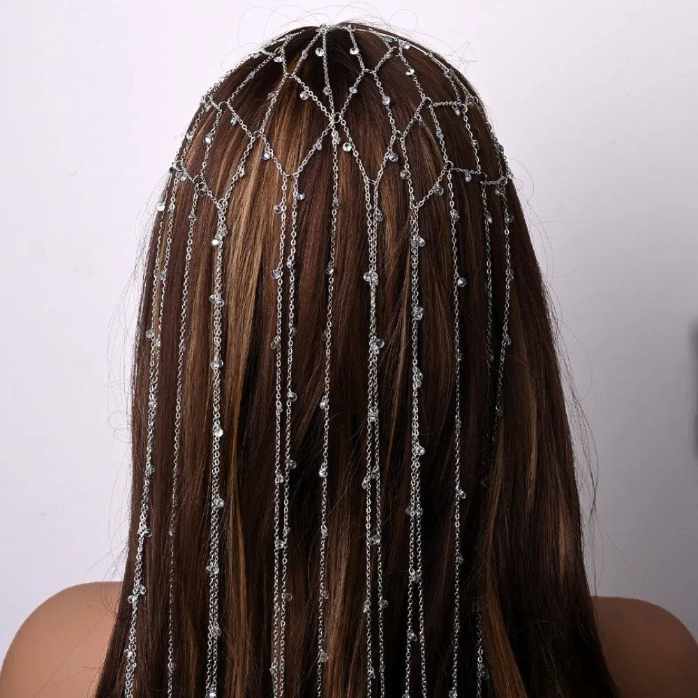 Gold and silver rhinestone headband with a sparkling electroplated finish and a long mesh tassel detail.