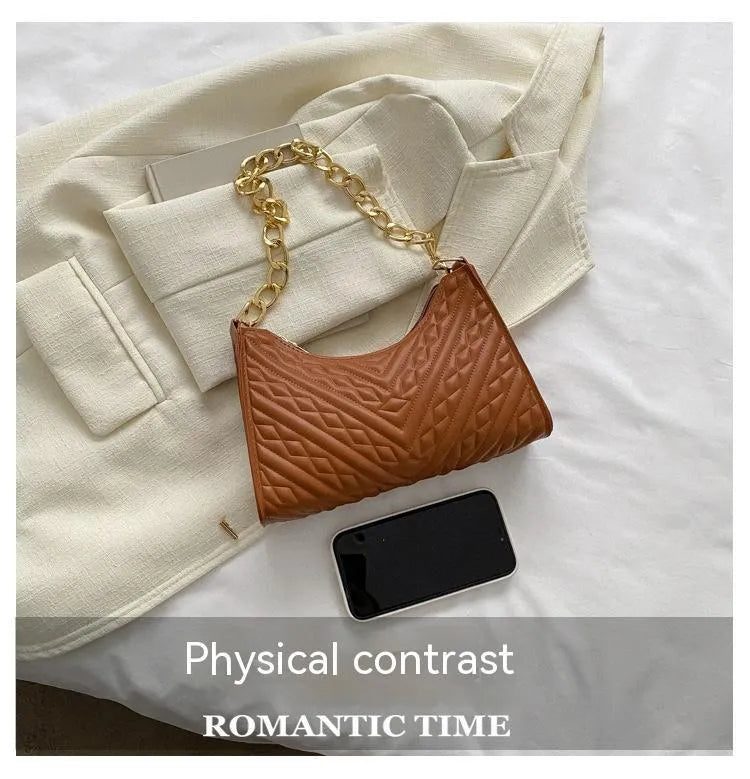 Brown pleated PU leather baguette bag with a gold-tone chain shoulder strap and a soft top handle.