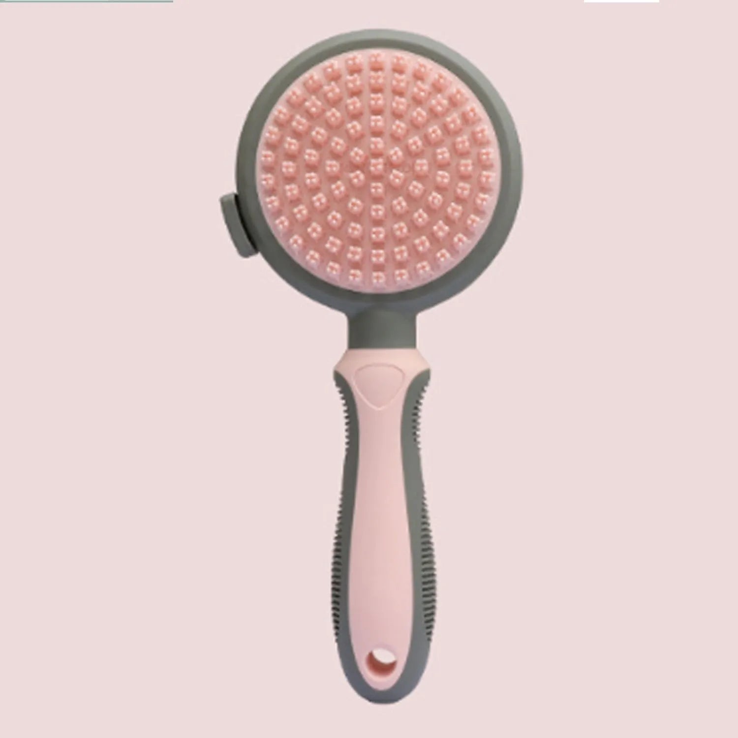 Pink and green double-sided cat brush with release button and attached flea comb