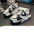 A pair of thick-soled leather casual shoes with a wedge heel and lace-up front fastening.