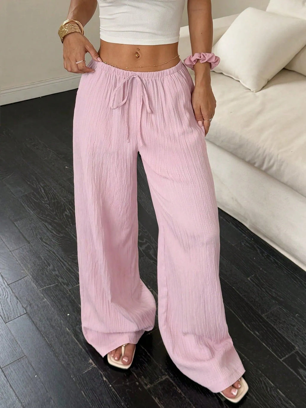 Women's black wide-leg trousers with lace-up waist trimming detail on mid-waist