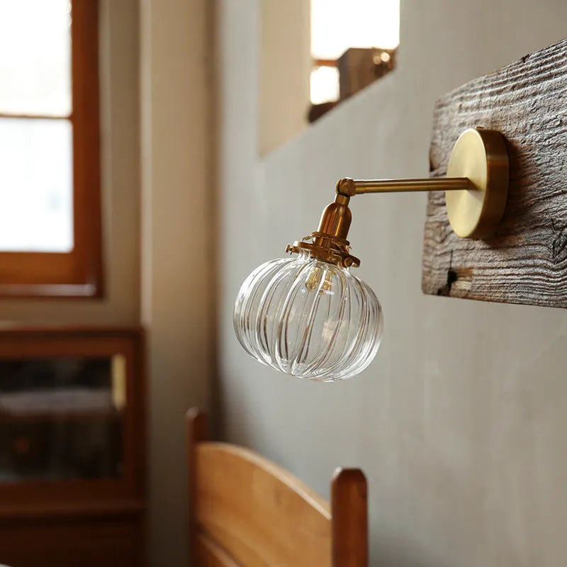Glass wall lamp with transparent shade for living room or bedroom lighting