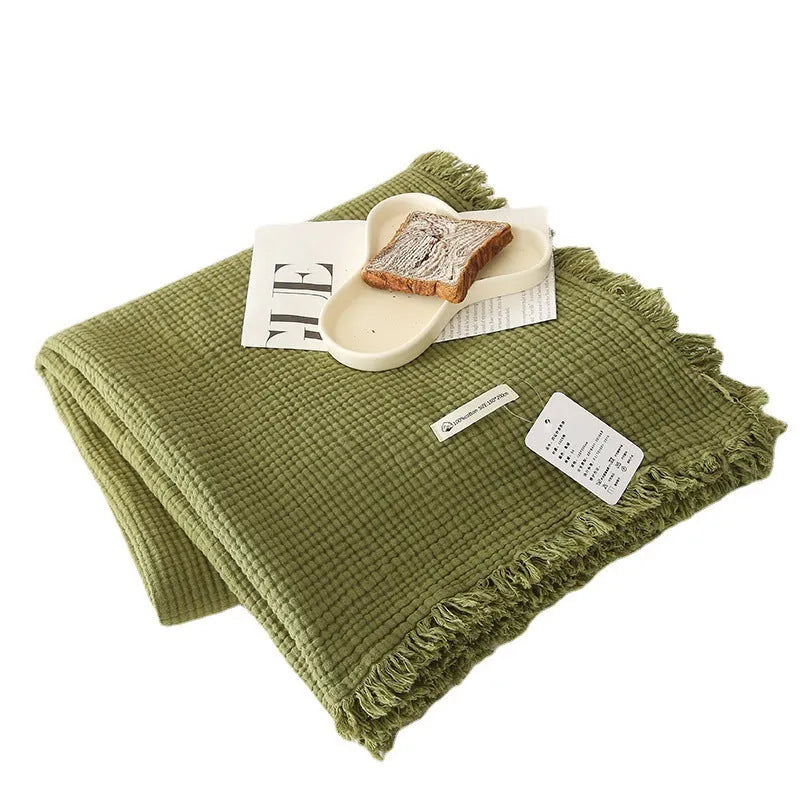 Four-layer cotton gauze blanket with tassel trim in avocado green colour