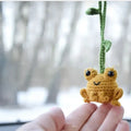 Handmade green plush frog woven car pendant hanging, showing soft texture and cartoon design.