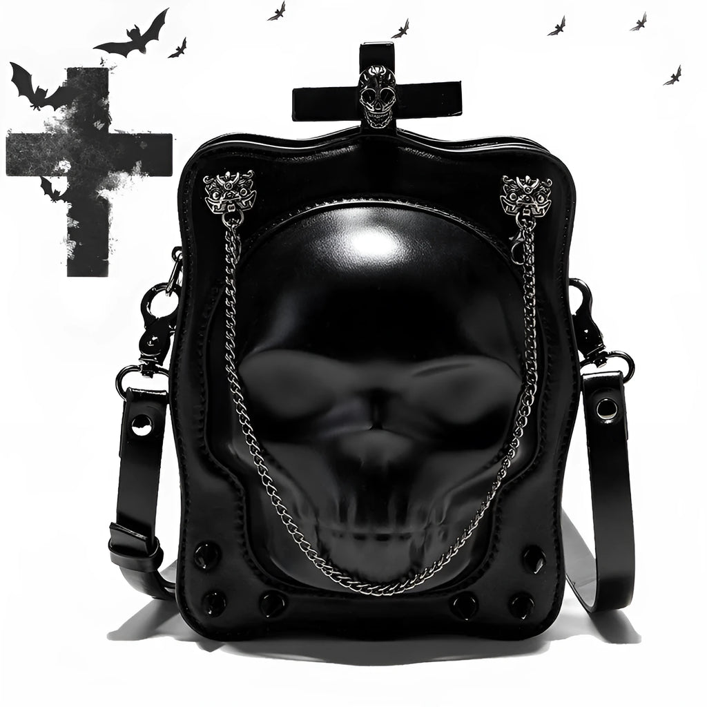 Black mini square crossbody bag with embossed skull design, metal chain strap, rivets, and contrast stitching.