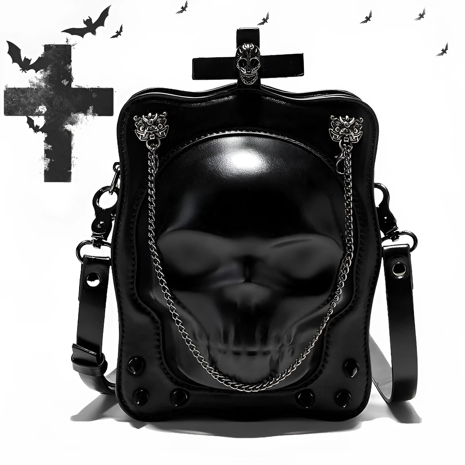 Black mini square crossbody bag with embossed skull design, metal chain strap, rivets, and contrast stitching.