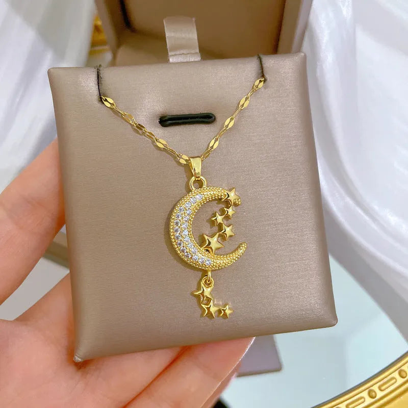 Geometric moon pendant necklace with diamond accents and tassel on stainless steel chain