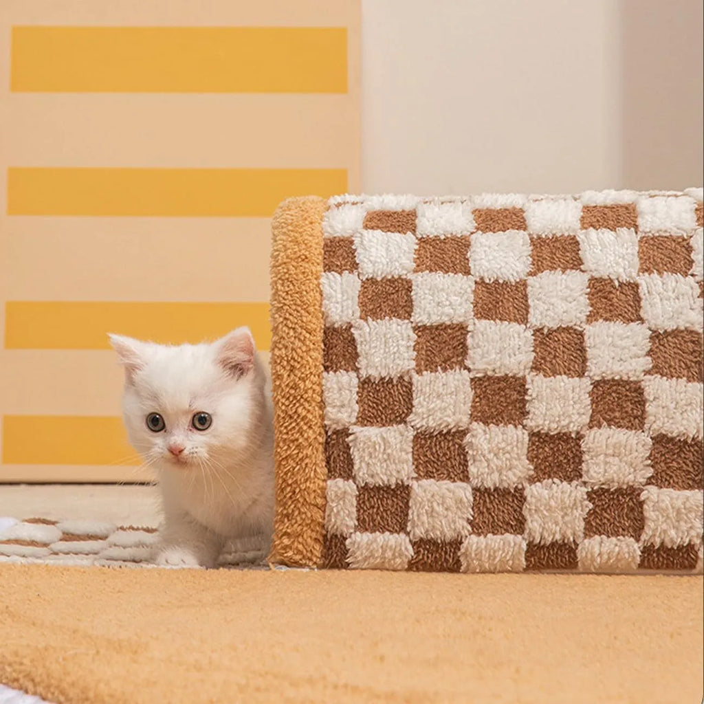 A plush fan-shaped dog and cat bed with an integrated tunnel, shown in a yellow plaid design.