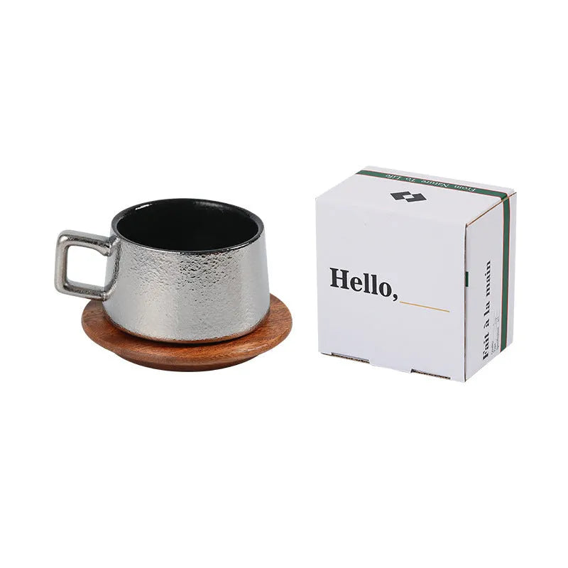 Gold and silver plated gift box next to a 250ml solid colour coffee travel mug.