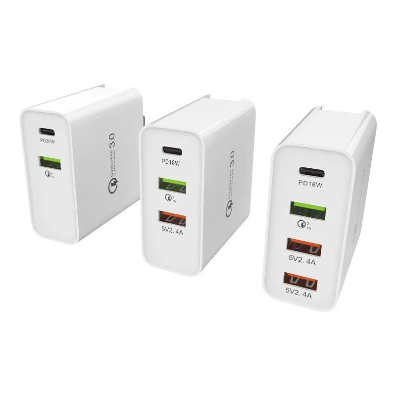 White 4-port fast wall charger with PD, QC, and USB ports on a table