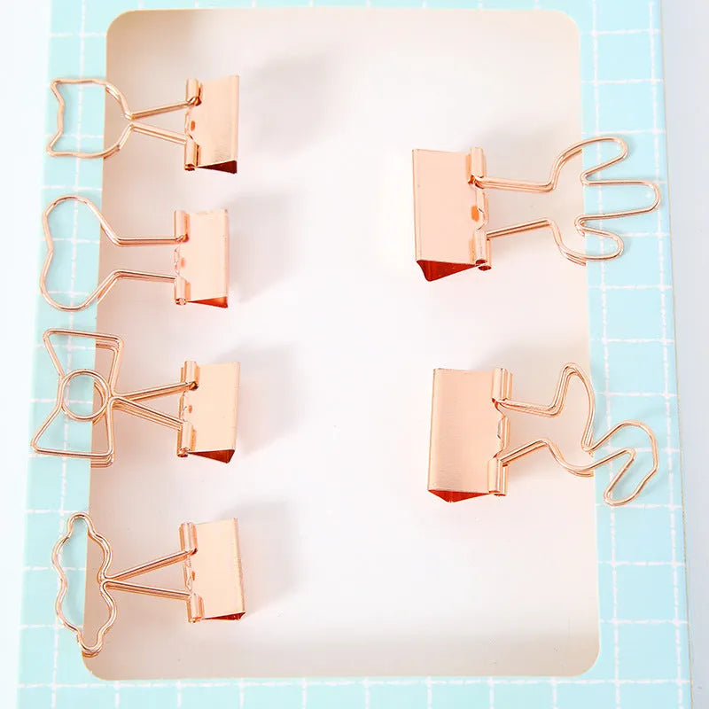 Gold metal paper clip with decorative charm attachment in flamingo design