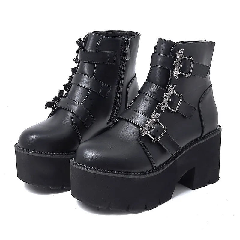 Black women's gothic punk Martin boots with bat buckle and side zipper on a thick heel.