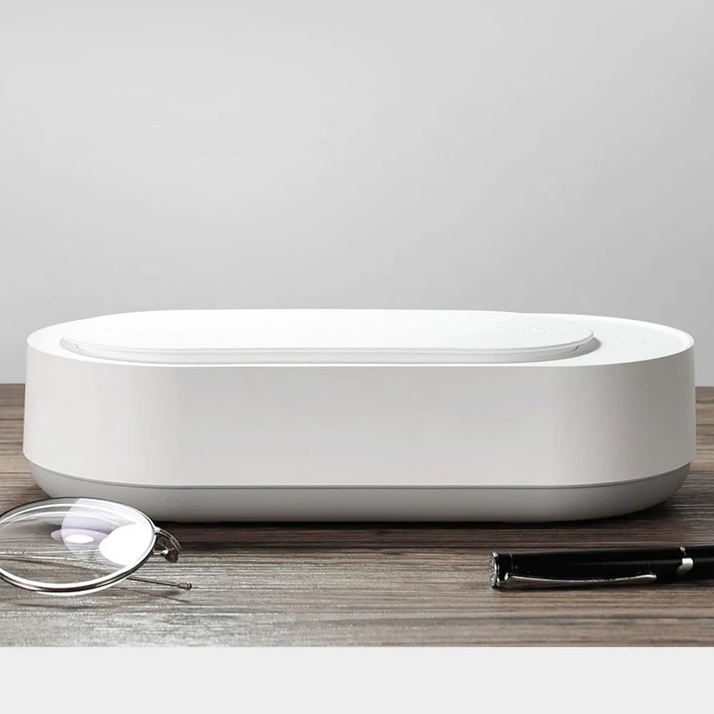 White portable ultrasonic cleaning machine with digital display and stainless steel tank.