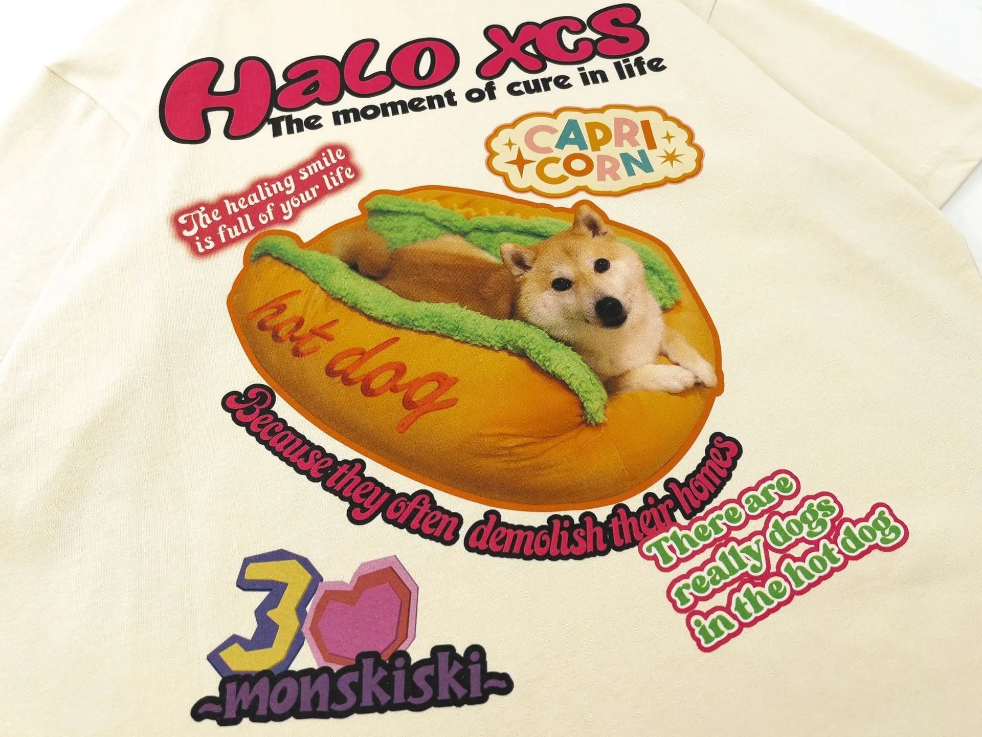 White loose-fit cotton t-shirt featuring a colourful cartoon print of a hamburger and a dog.