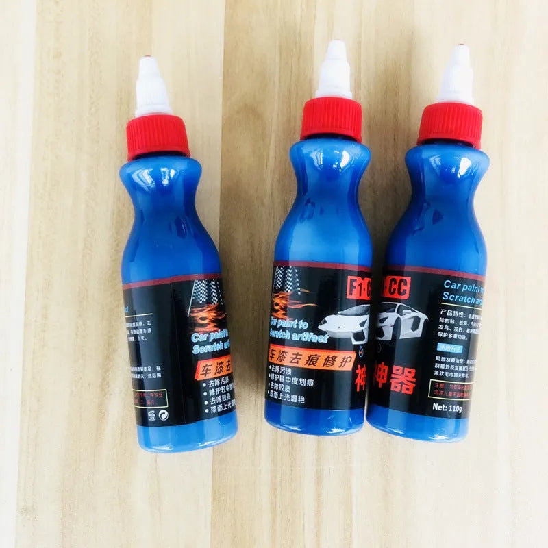 Small blue car scratch repair agent bottle with integrated wiping tool for automotive paintwork