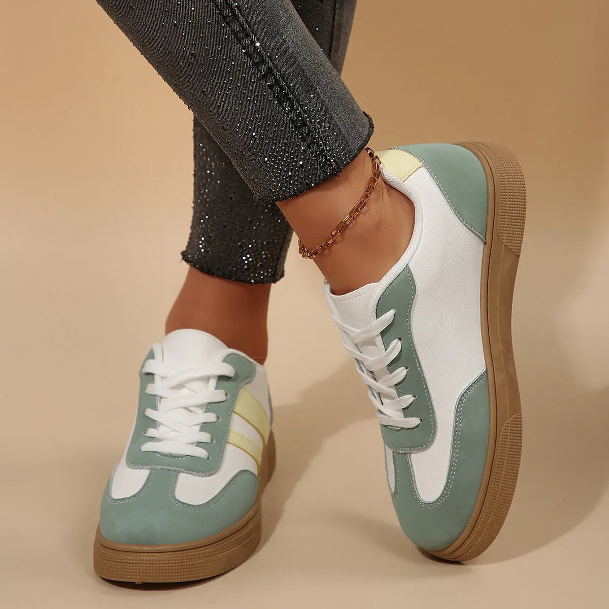 Green women's retro sports shoes with white cross straps and a low flat heel