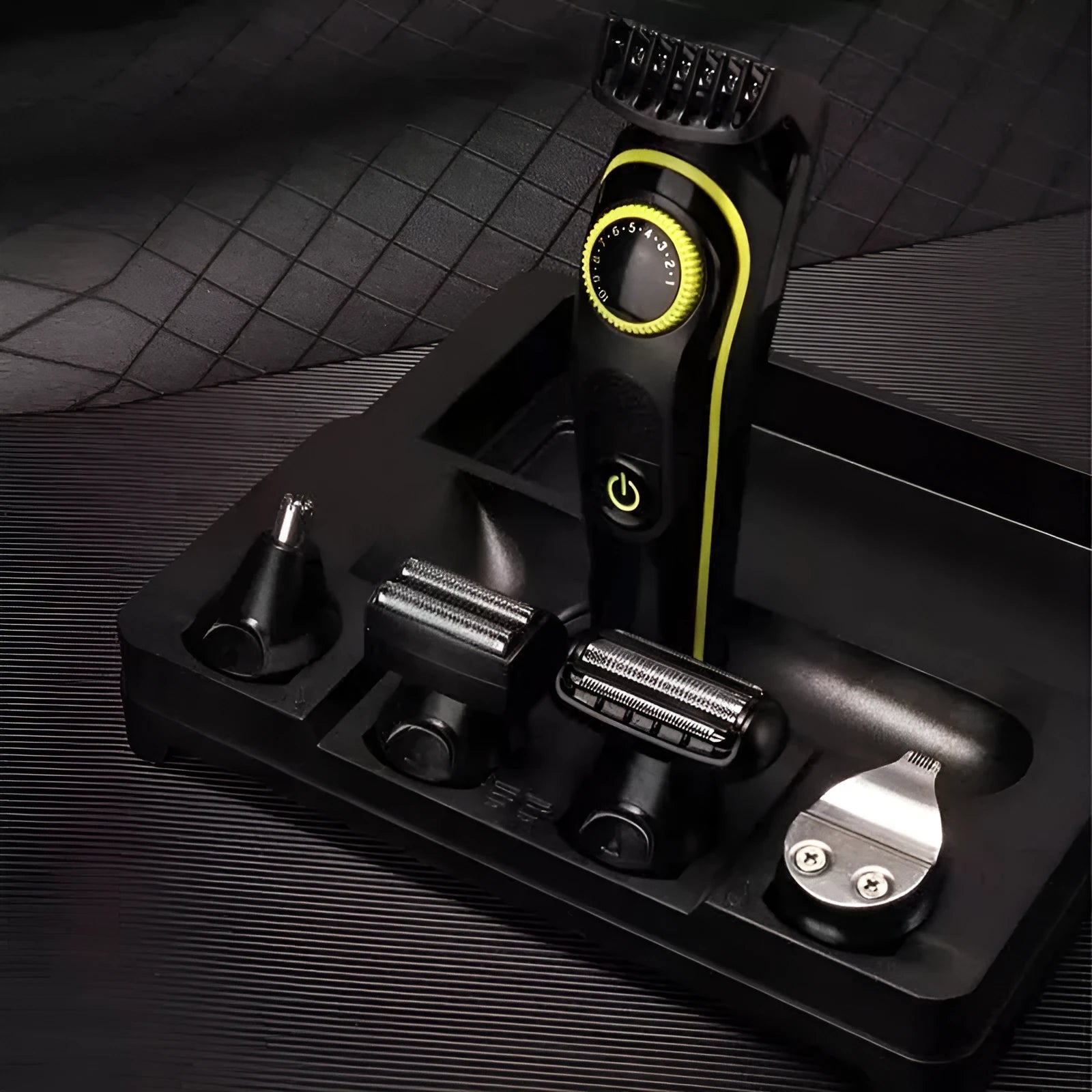 Black KM-696 USB rechargeable electric hair clipper set with stainless steel blades and cleaning brush.