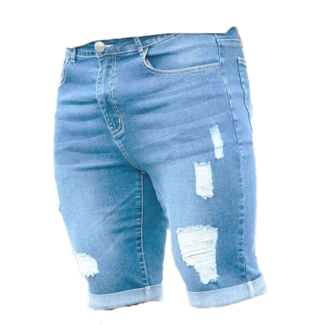 Men's sky blue denim shorts with distressed multi-hole design, low waist, and zip fly opening
