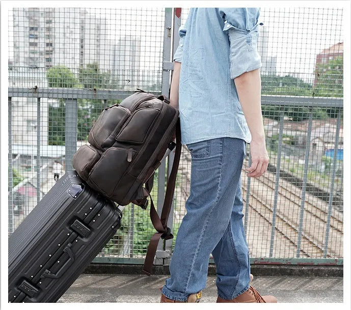 Dark brown genuine leather backpack with 17-inch laptop compartment and multiple organisational pockets