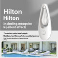 White ultrasonic essential oil diffuser with remote control on a wooden table