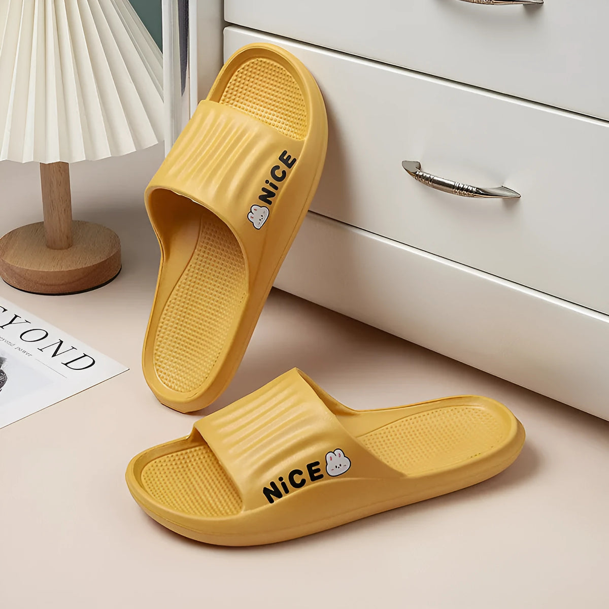 Unisex adult EVA flip flop slippers with cartoon pattern in multiple colours on a non-slip sole.