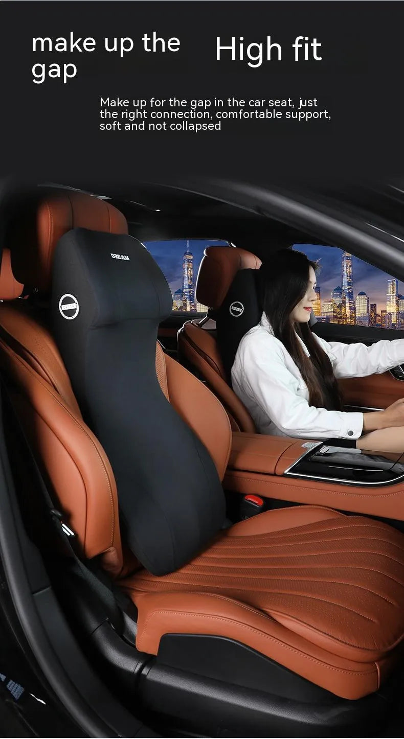 Black automotive memory foam cushion and headrest lumbar support pillow set on a car seat.