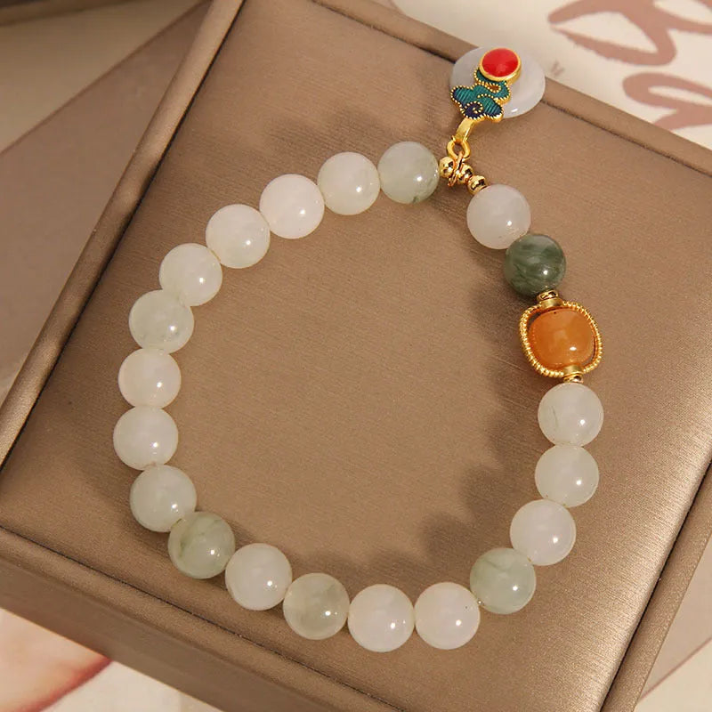 Women's ice jade crystal bracelet with xiangyun peace buckle and pearl accents on a retro-style chain.