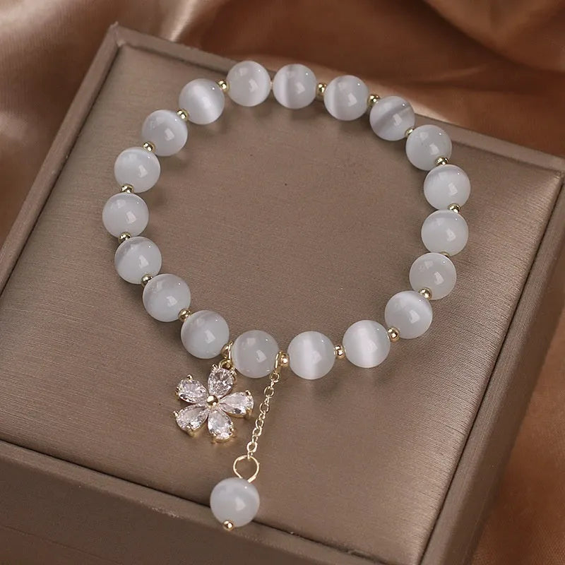 Women's white cat's eye crystal bracelet with flower tassels and safety buckle