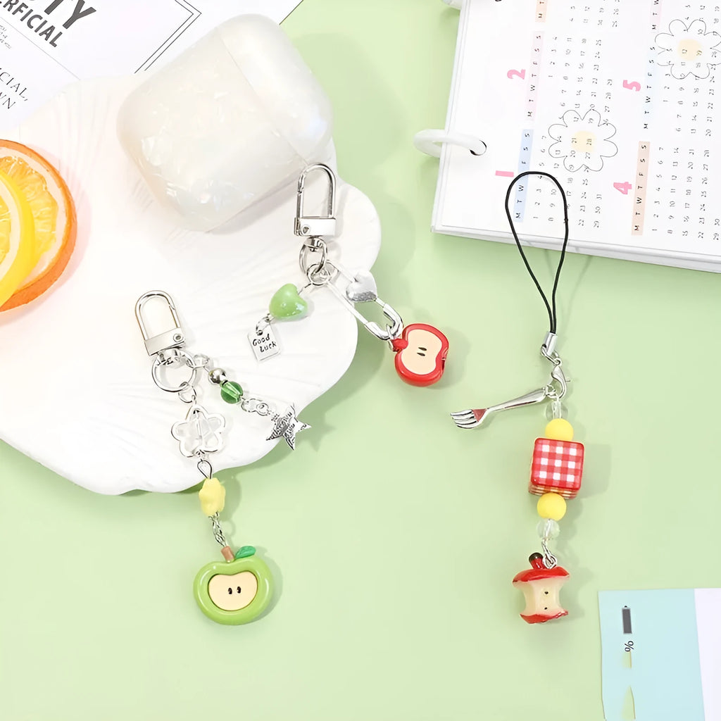 Cute fruit design mobile phone charm keychain in plastic resin with apple or strawberry motif.