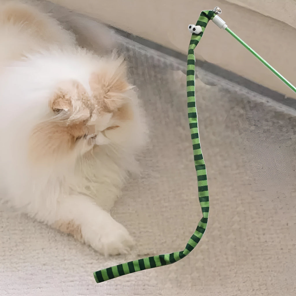 Green cat wand toy with long plush strip on a polycarbonate pole, shown mid-swing.