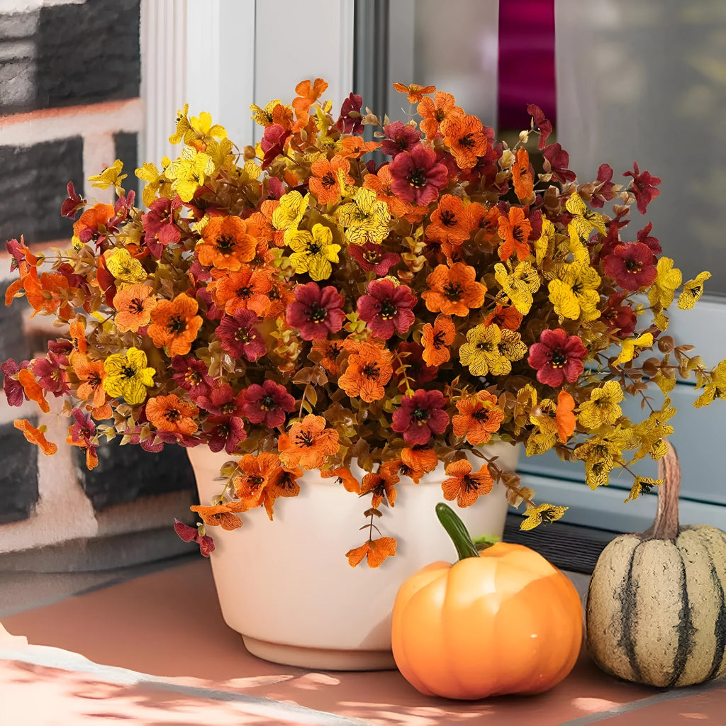 Artificial silk flower bouquet in autumn colours on a plastic stem for home and event decoration.
