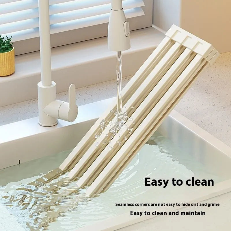 Milky white stainless steel foldable kitchen draining rack with tri-fold design on sink