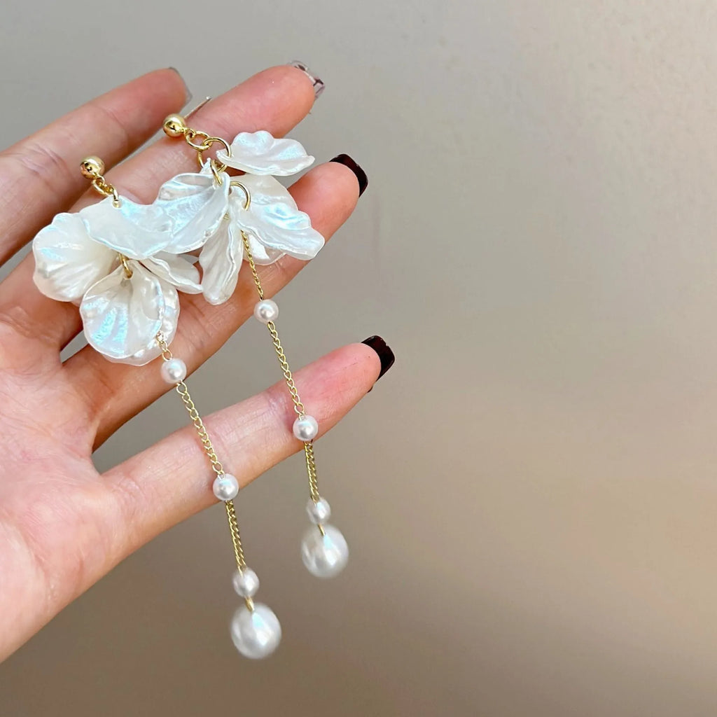 Women's acrylic shell pearl tassel earrings with 8.8cm drop length showing four ear clip style options