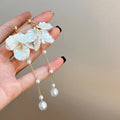 Women's acrylic shell pearl tassel earrings with 8.8cm drop length showing four ear clip style options