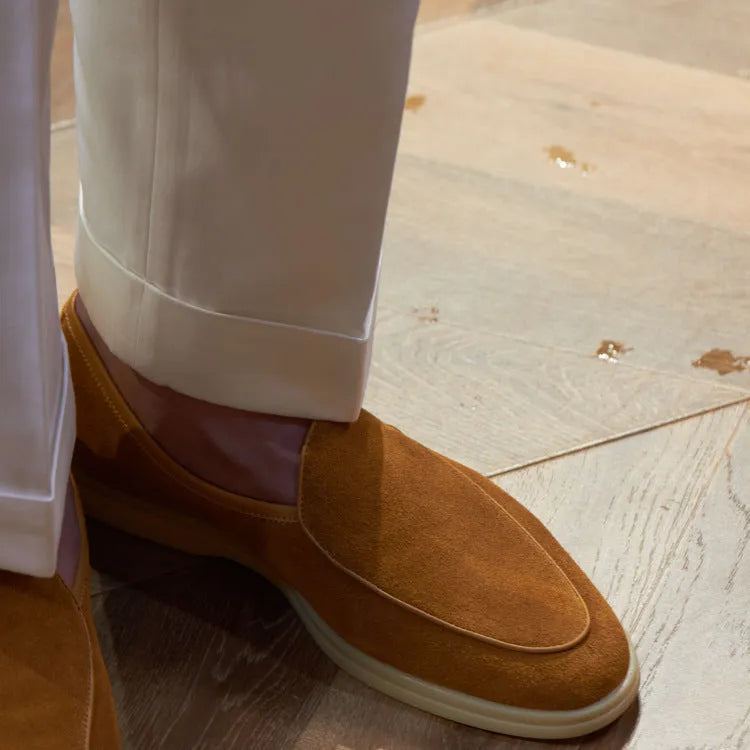 Men's brown genuine leather handmade loafers on a white background.