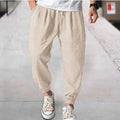 Men's loose-fitting cotton trousers with elasticated ankle bands in light green colour showing casual summer style