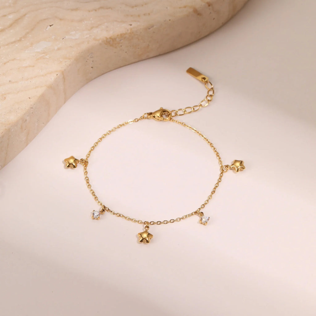 Women's titanium steel bracelet with 18K gold plating and a geometric hexagonal zircon star pendant.